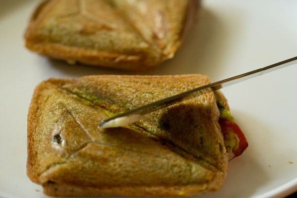 applying butter on Mumbai masala toast sandwich