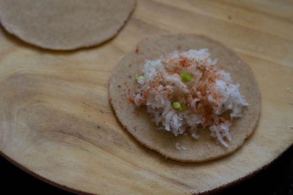 add grated mooli filling on paratha dough