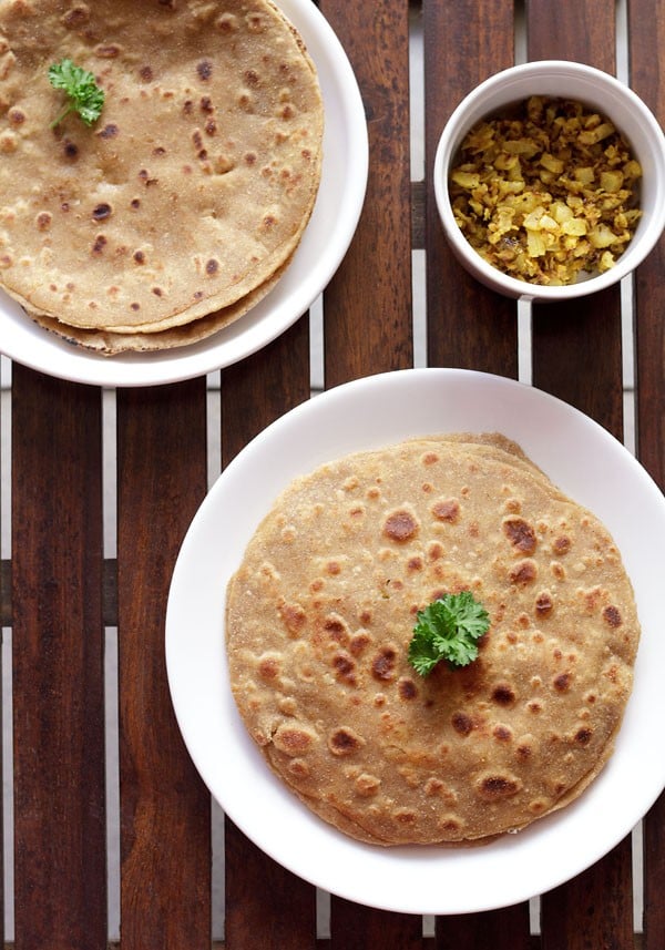 mooli paratha served on a white plate.