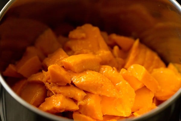 chopped mangoes in a blender