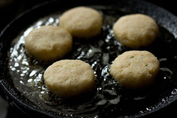 frying corn patties on a tawa