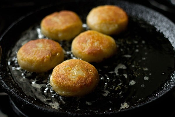 flipping and frying the other side of corn pattice