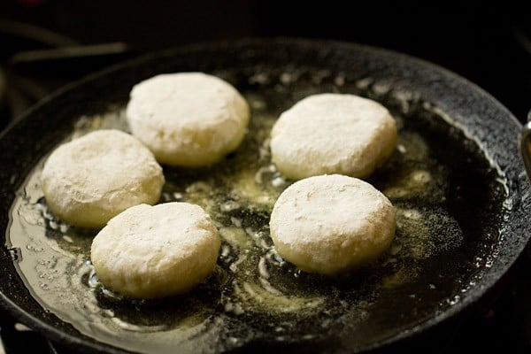 frying farali patties on a tawa