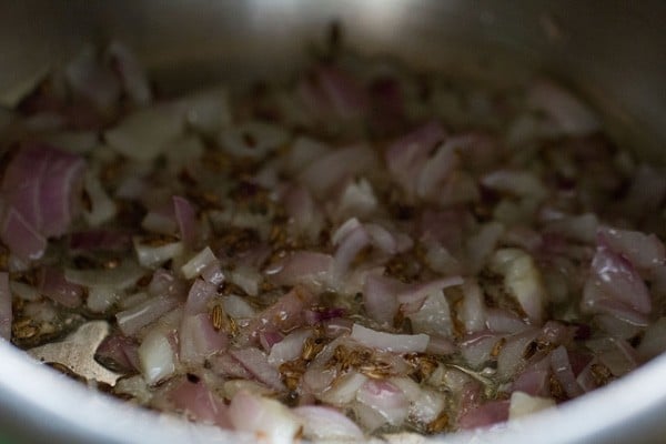 onions being sautéed in cooker