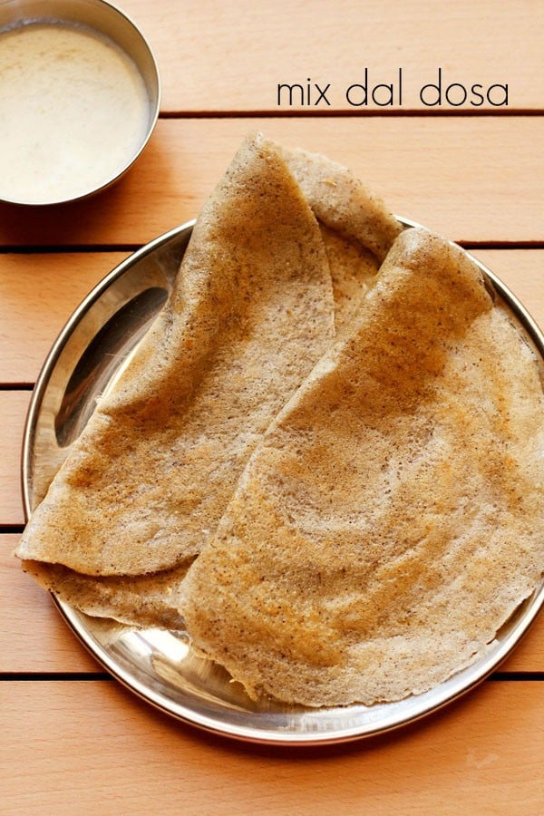 mix dal dosa served on a plate with a side of coconut chutney.