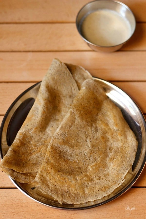 mixed dal dosa served in a plate with a side of coconut chutney