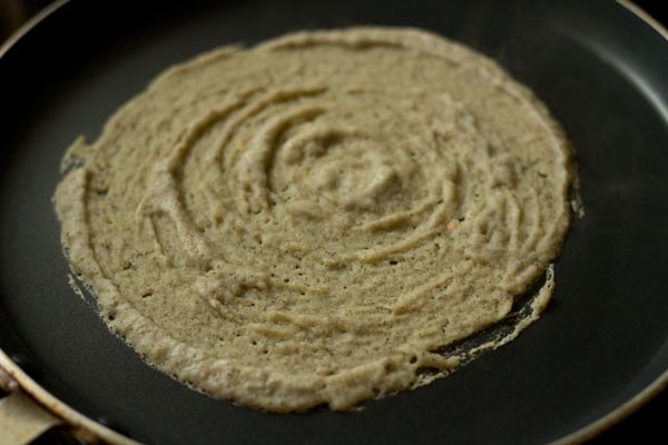 mixed dal dosa batter spread on tawa