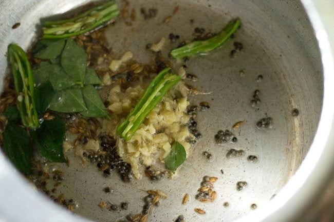 curry leaves, chopped ginger and slit green chili added to cooker. 