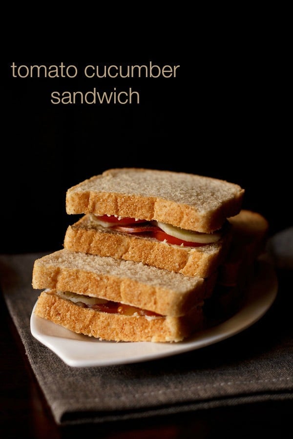 tomato cucumber sandwich served on a plate with text layover.
