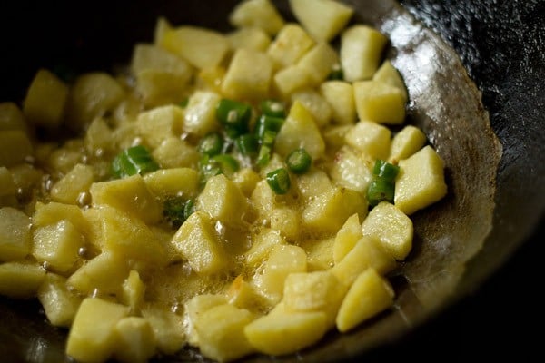 green chillies added on sautéed potatoes