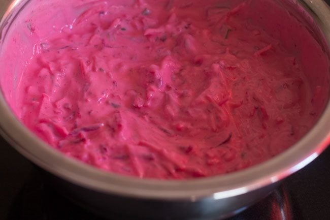 seasonings mixed with beetroot raita in the bowl