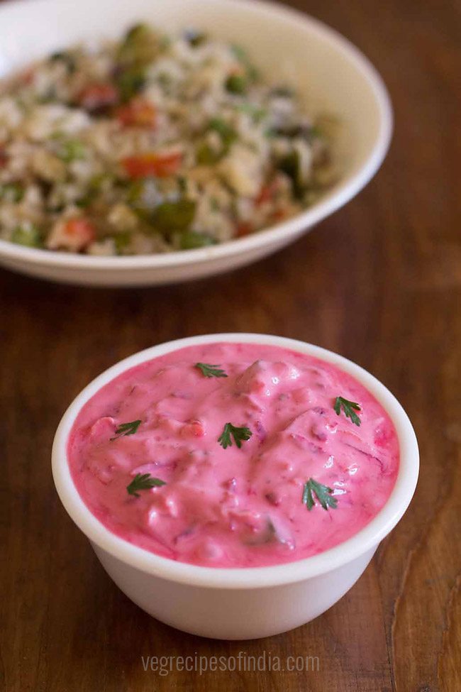 beetroot raita in white glass bowl on a wooden board