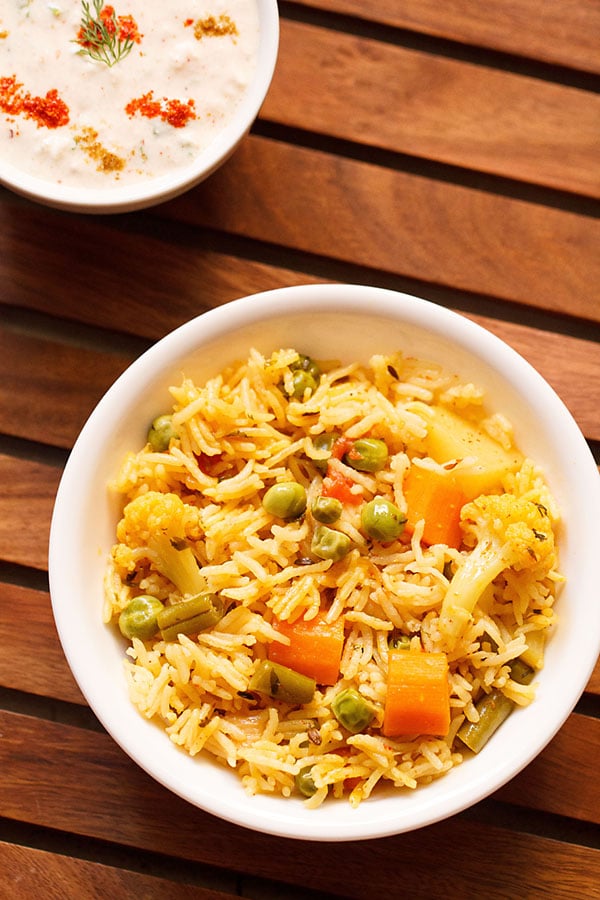 instant pot veg pulao served in a white bowl on a wooden tray