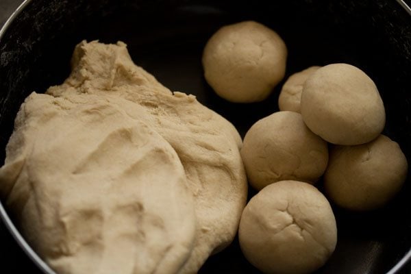 kneaded dough and dough balls in the bowl