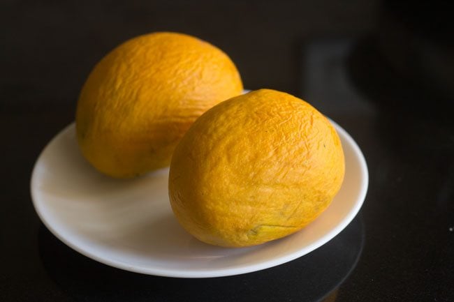 rinsing and wiping ripe mangoes