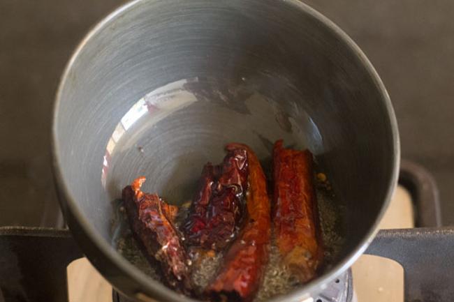 frying dried red chilies, fenugreek seeds with mustard seeds 