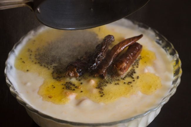 pouring tempering on mango-curd mixture