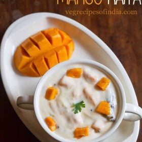 mango raita topped with mango cubes in a white bowl.