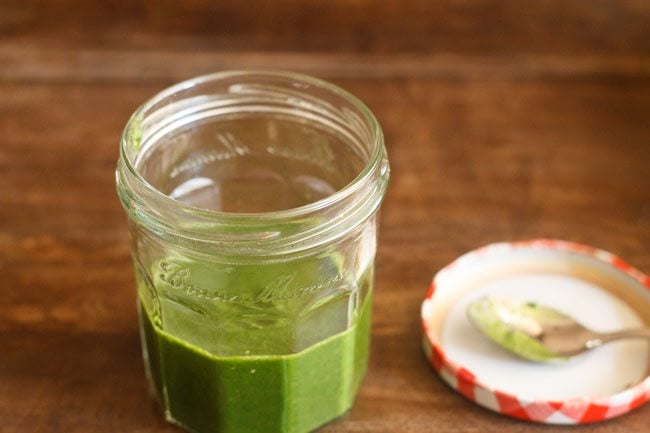 mint coriander stored in a small glass jar