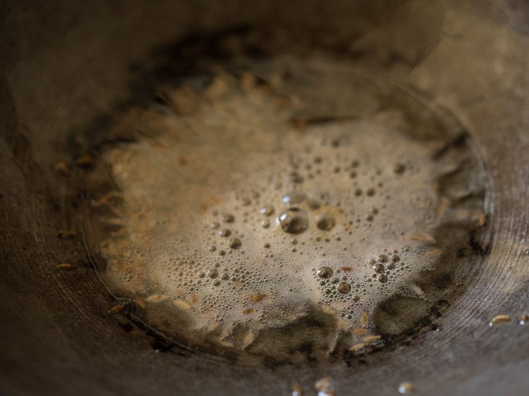 cumin seeds tempering in oil in the kadai