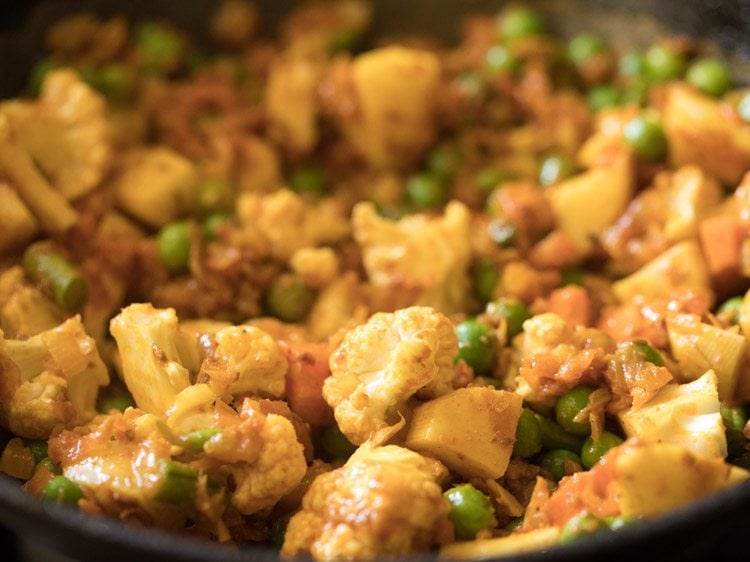 mixed vegetables tossed in tomato onion masala for curry recipe