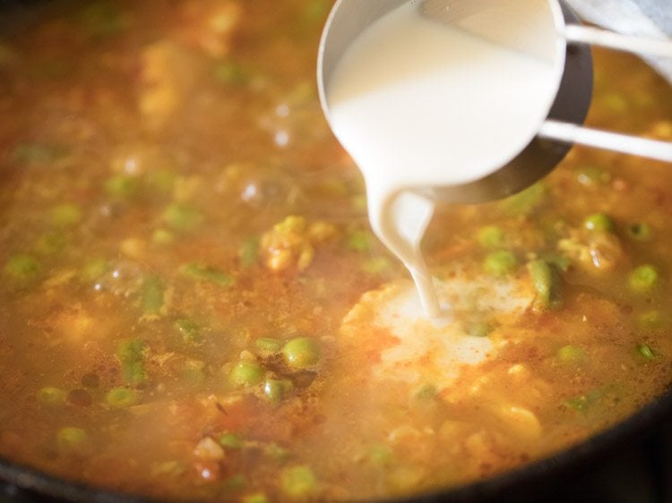 cream being added to the mix veg curry