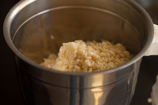 adding soaked ingredients in wet grinder jar