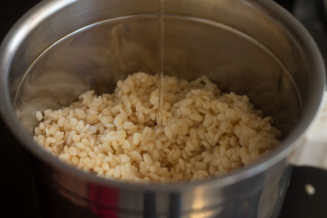 adding water to soaked ingredients in jar