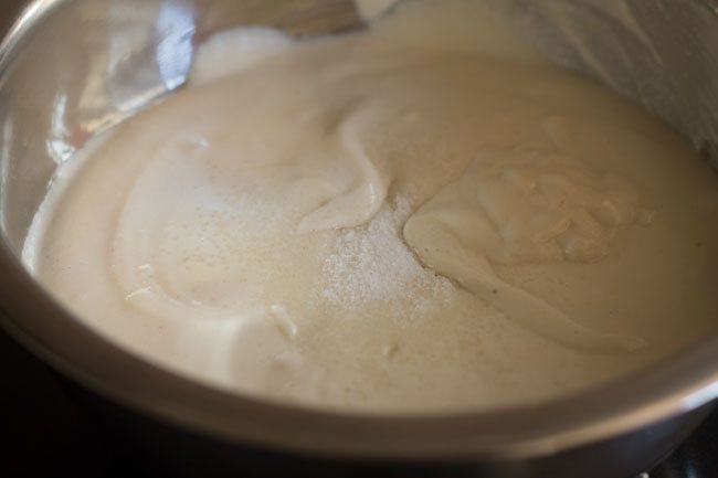 adding salt to urad dal batter