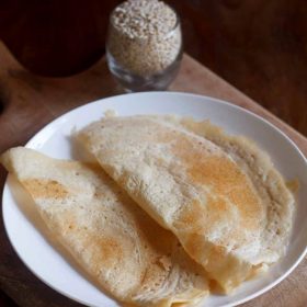 urad dal dosa on a white plate.