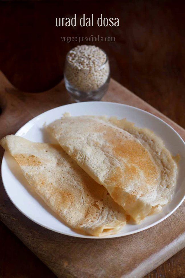 urad dal dosa on a white plate.