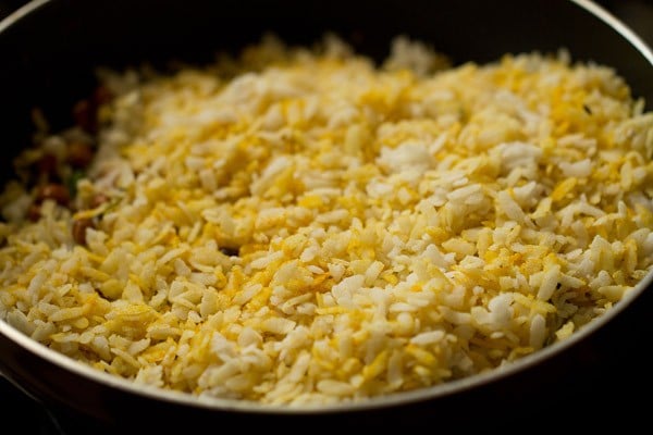 prepared poha mixture added to onion mixture.