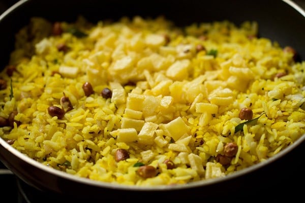 sautéed potatoes added to poha mixture for making batata poha.