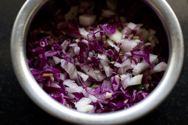 finely chopped cabbage ginger green chillies onions in a bowl