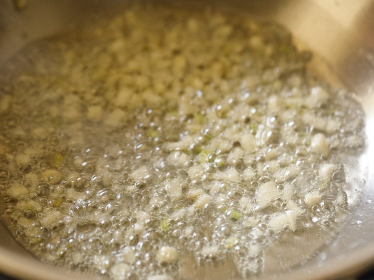 sauteing garlic in a kadai
