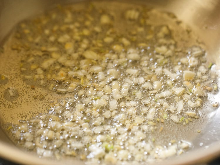 sauteing garlic in a kadai