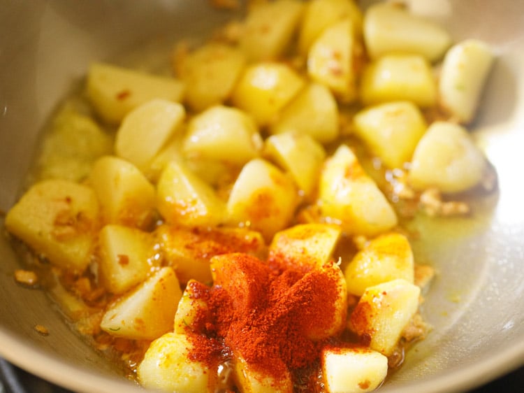 turmeric and chilli powder added to potatoes
