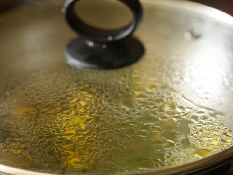 cooking dill leaves and potatoes in the kadai