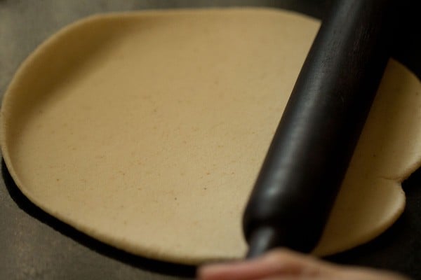 rolling puri dough with rolling pin