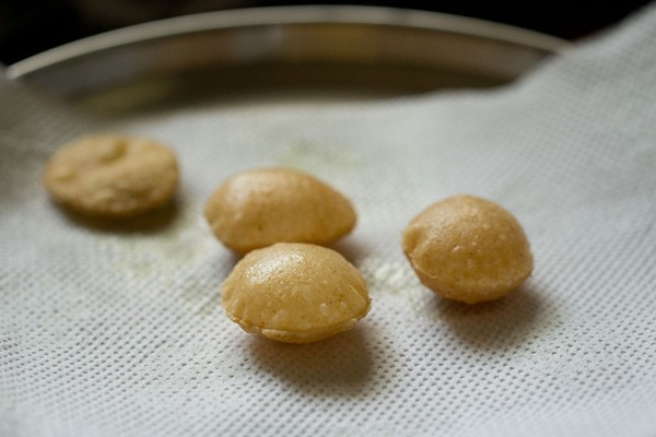 fried puri on kitchen paper towels