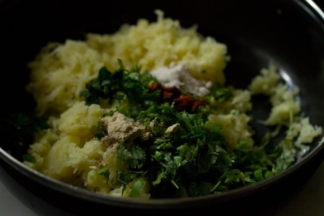 herbs and spices added to grated potatoes