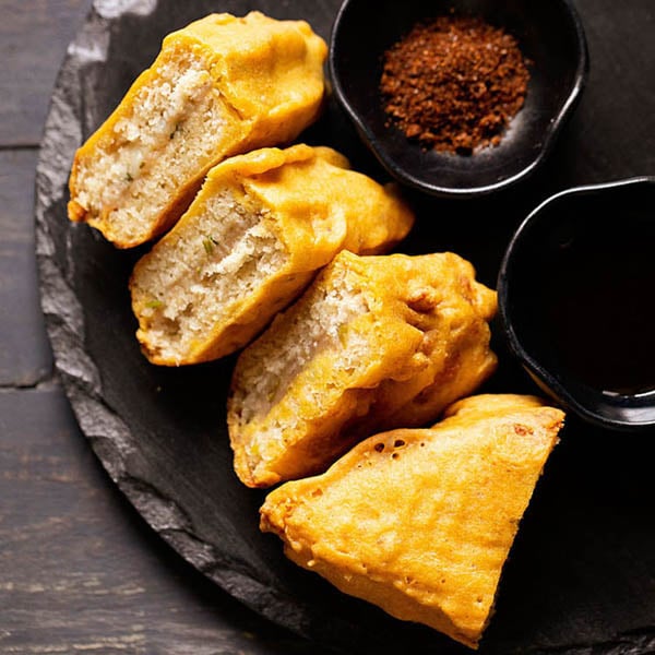 bread pakora on a black granite platter.