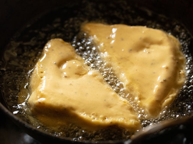 two bread pakoda getting fried in hot oil