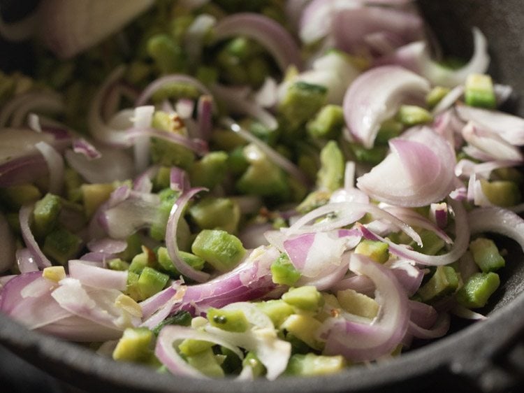 mixing onions with karela