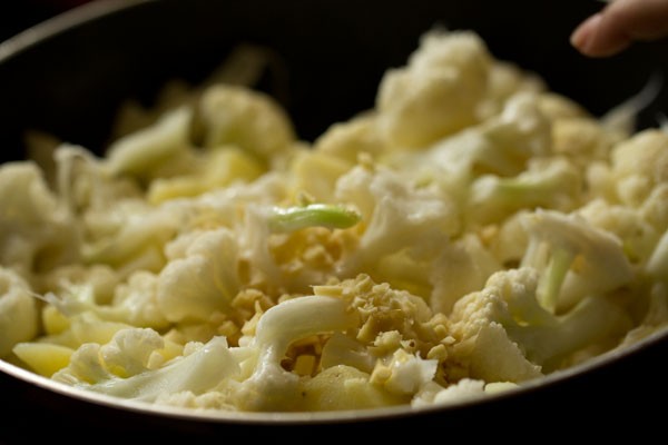 adding ginger to cauliflower florets