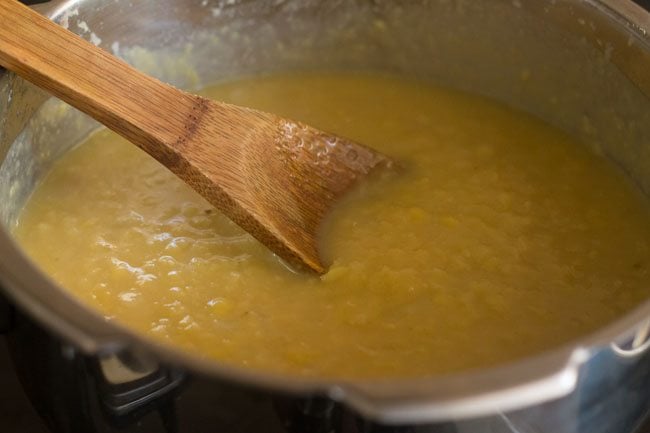 mashing the cooked lentils