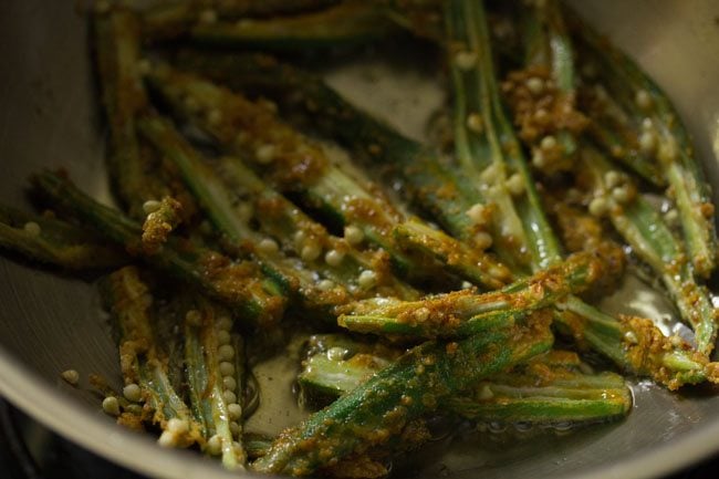 frying marinated sliced bhindi in hot oil. 