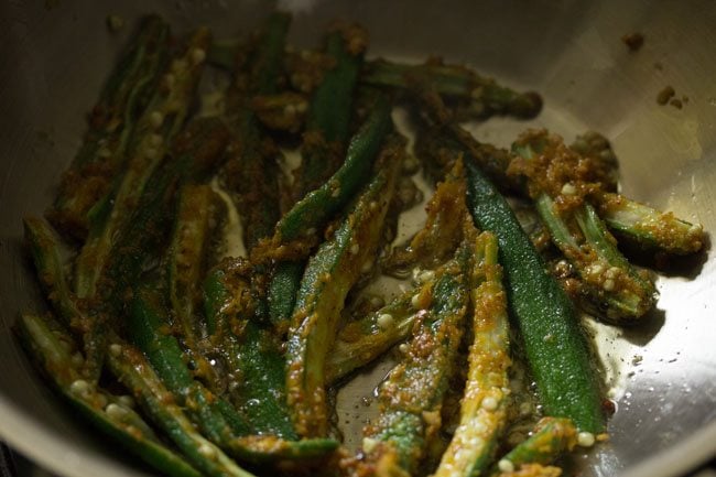 frying marinated sliced bhindi in hot oil. 