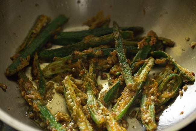 frying marinated sliced bhindi in hot oil. 