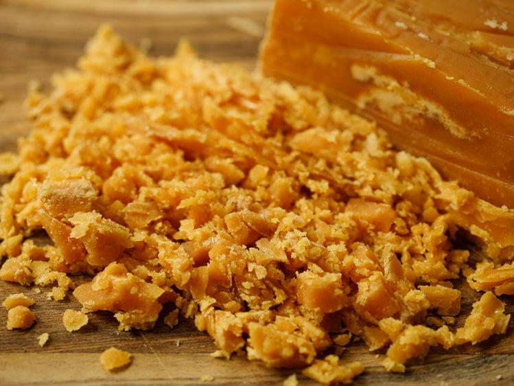 chopped jaggery on a wooden board